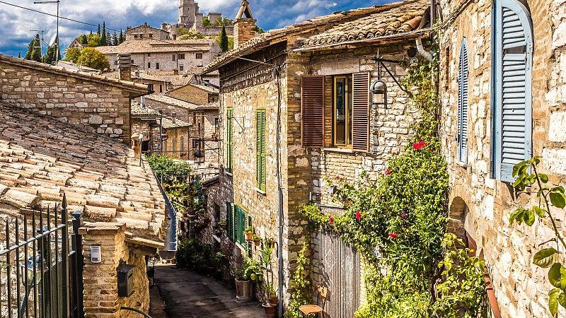 small village in Umbrian hills, Italy, stone cottages, olive groves, winding country roads, peaceful mountain landscape