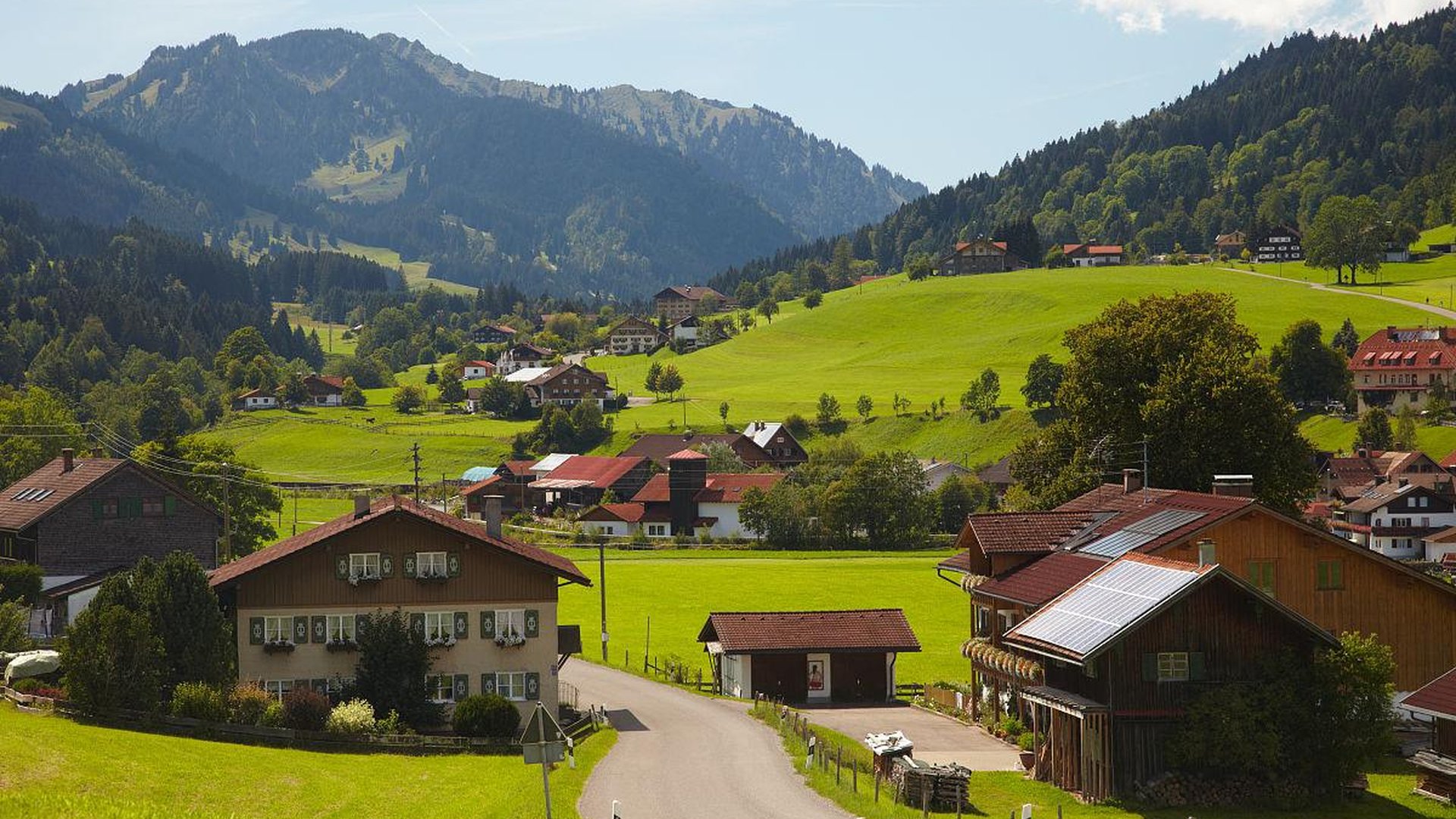 tourist respectfully observing daily life in a small european village, avoiding disruption, natural setting