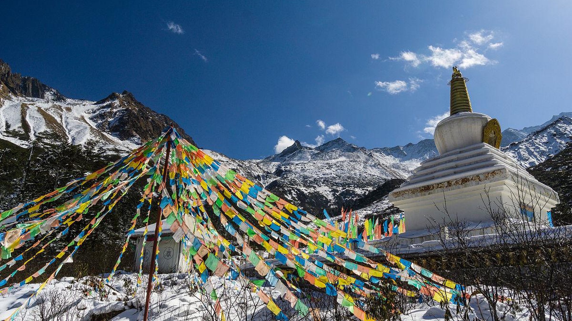 Tibetan monastery high plateau snow-capped mountai